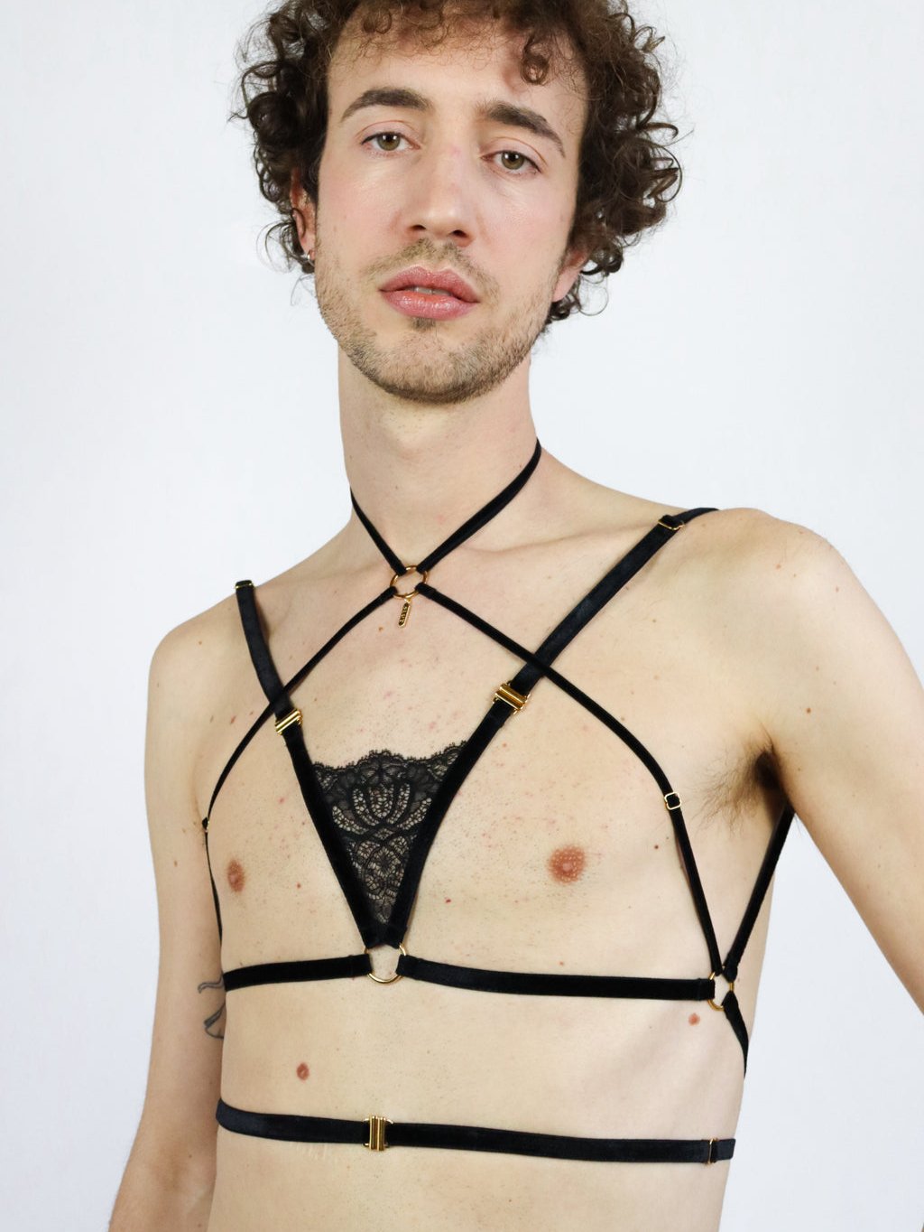 Front closure black chest harness made with eco-friendly velvet straps, a black french lace center piece, and a gold pendant.