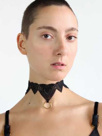 Black lace choker with heart shaped design and gold o-ring pendant. Sustainable lingerie accessory