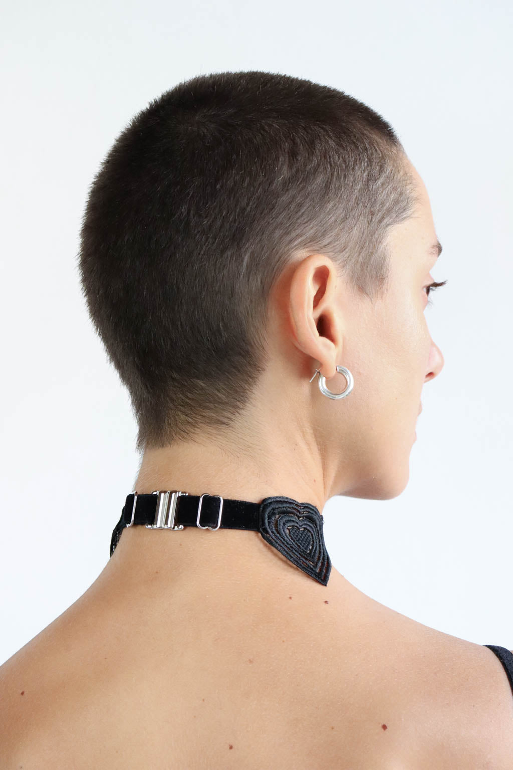 Back view of an adjustable black velvet and lace choker with a silver clasp. Gender-free lingerie accessory