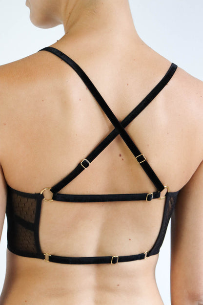 Close up view of the back of an adjustable multiway black lace crop top with 4 interchangeable velvet straps and gold hardware. Size small