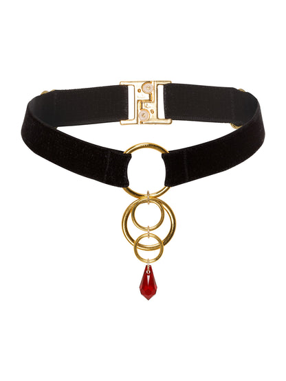 Adjustable black velvet choker with a gold 4 o-rings charm attached to a red Swarovski crystal pendant.