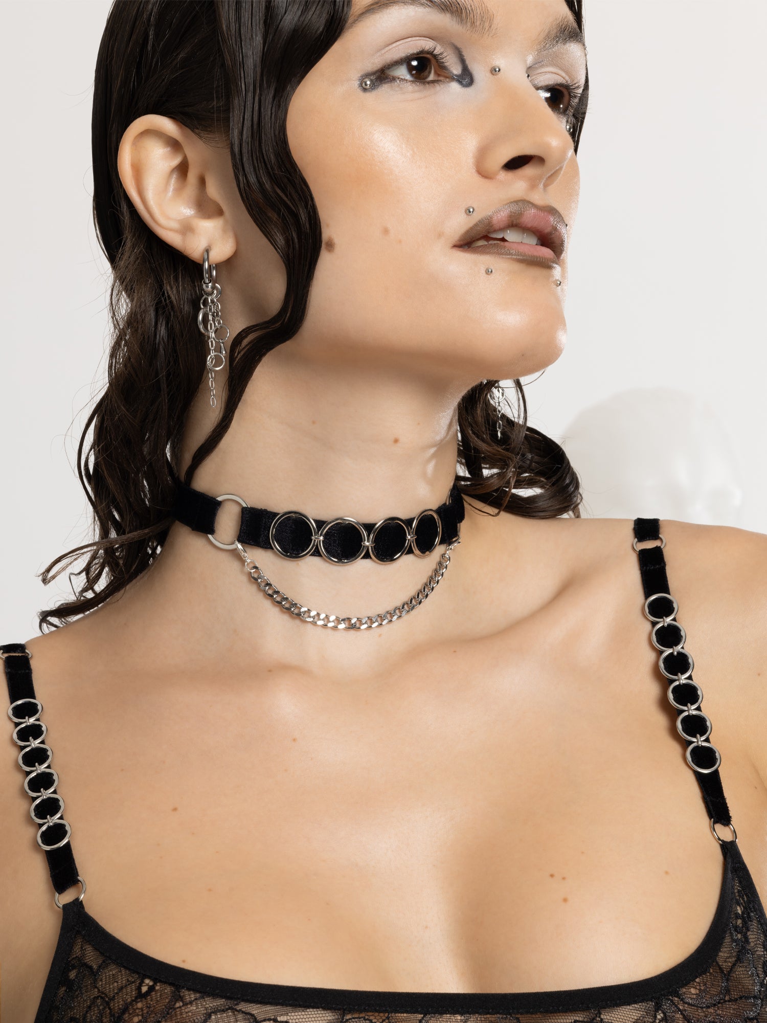 Adjustable Black Velvet choker with eco-friendly silver o-rings details and a thin chain attached.