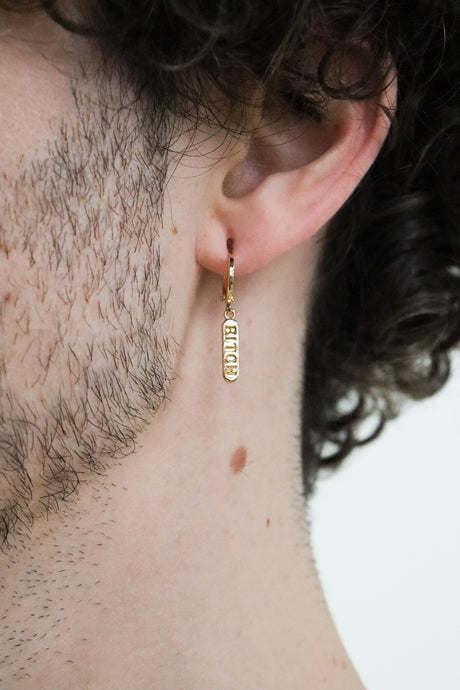 Model wearing a gold plated huggie earring with a 