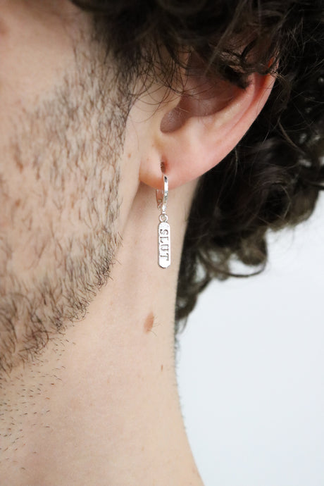 Model wearing a silver plated huggie earring with a 