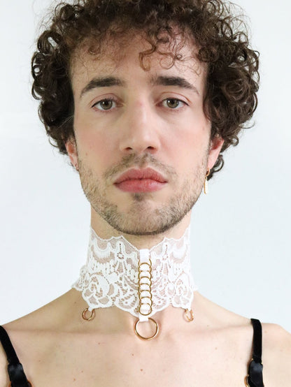 Man wearing a unisex fine white lace collar with eco-friendly gold o-rings.