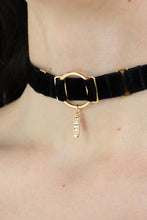 Load image into Gallery viewer, Close-up of a woman wearing an O-ring black velvet choker with a gold charm with &quot;Bitch&quot; engraved.
