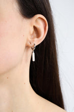 Load image into Gallery viewer, Woman wearing a silver plated huggie earring with a &quot;bitch&quot; charm.
