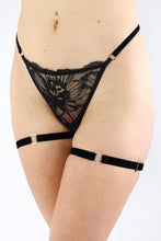 Load image into Gallery viewer, Woman wearing a pair of black velvet garters with silver hardware.
