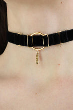 Load image into Gallery viewer, Close-up of a woman wearing an O-ring black velvet choker with a gold charm with &quot;Slut&quot; engraved.
